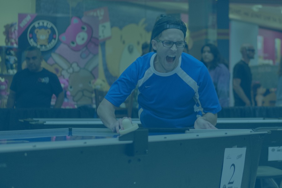 People playing air hockey.